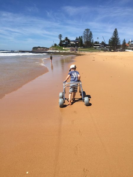 Rozzy Dickson and her children taking advantage of the beautiful beach and rock pools with the WheelEEZ® Walker Kit added to their standard pediatric walker.